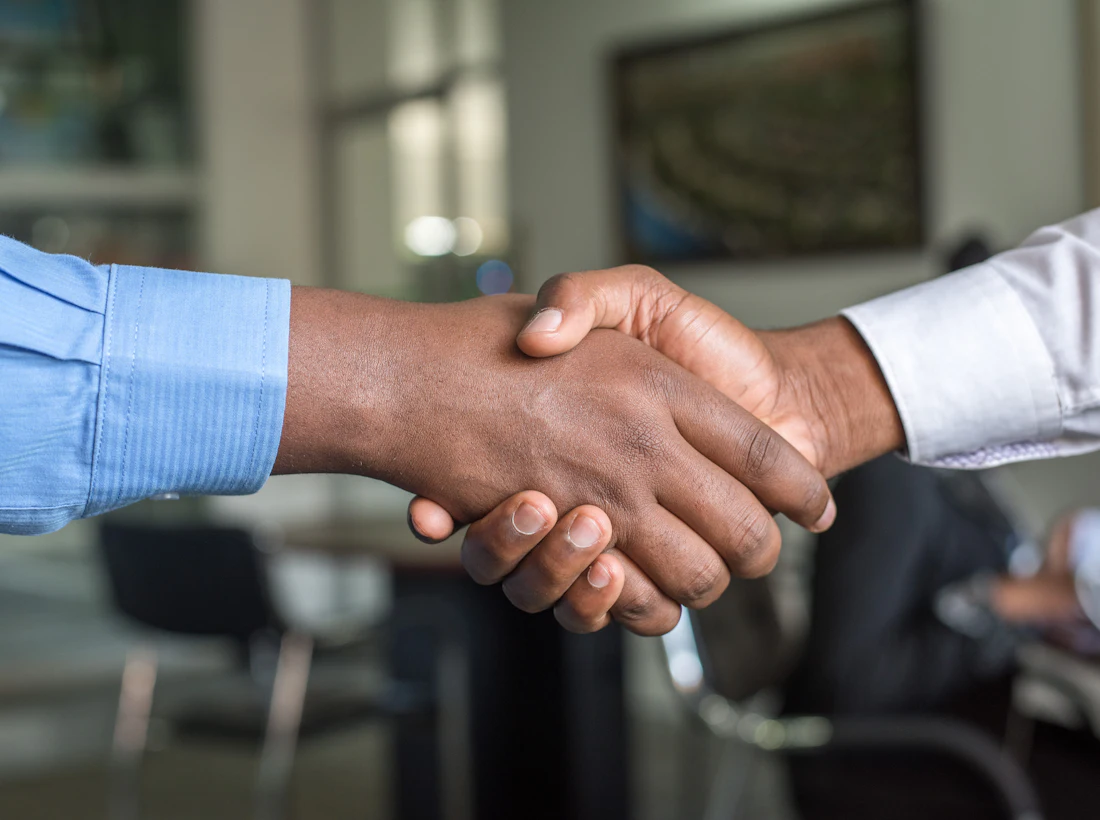 Two professionals shaking hands to close an honest property deal